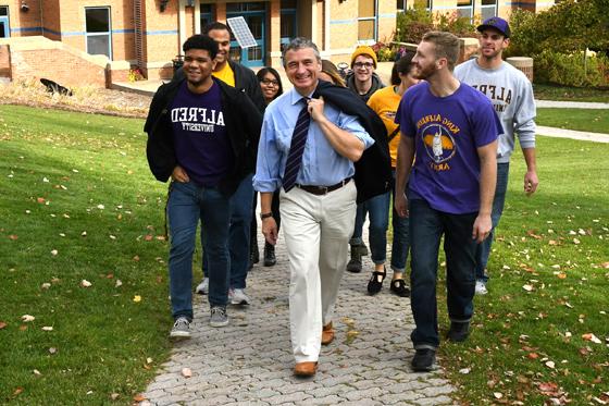 President Zupan walking on campus with a group of students